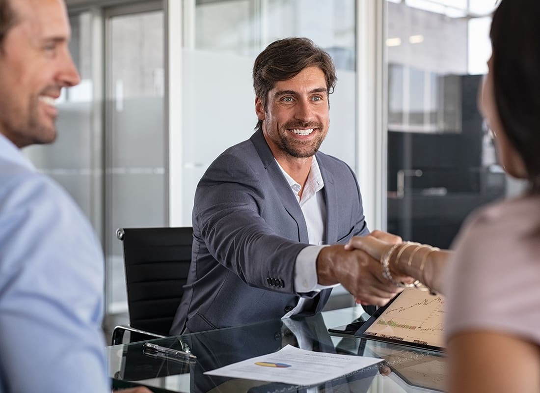 About Our Agency - Professionals Smiling and Shaking Hands