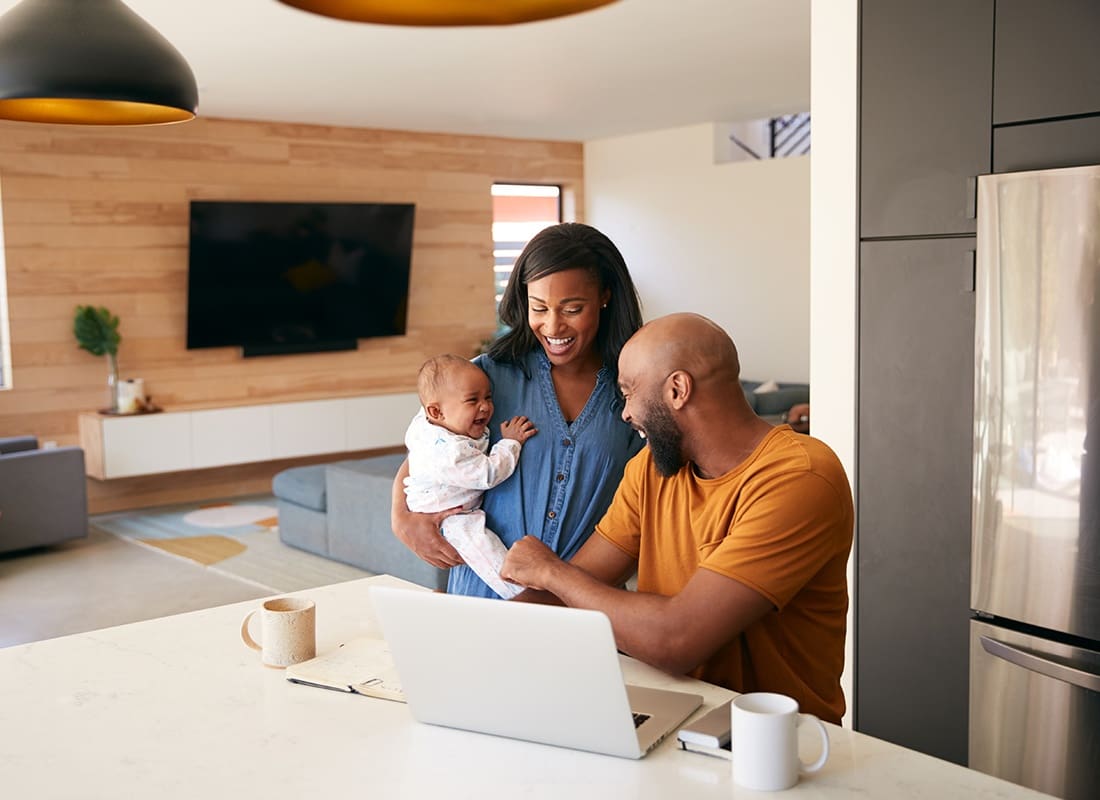 Personal Insurance - Loving Family Laughing With Their Baby at Home