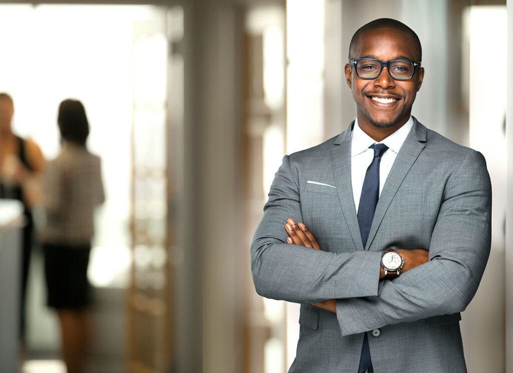 We Are Independent - Friendly Business Man Standing in an Office